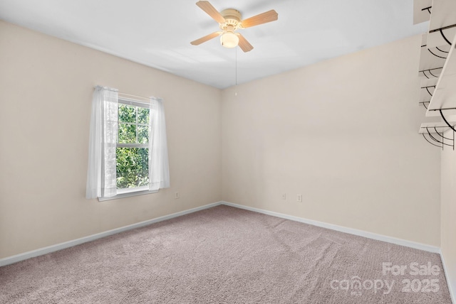 carpeted spare room with ceiling fan