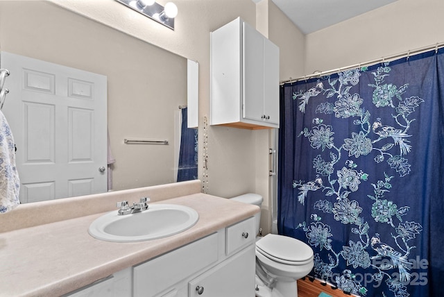 bathroom featuring vanity, hardwood / wood-style floors, and toilet