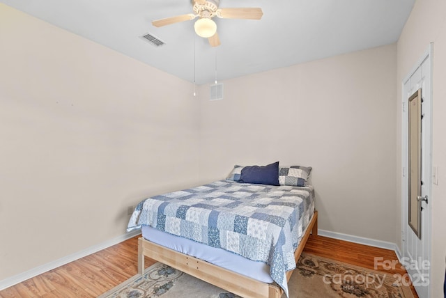 bedroom with hardwood / wood-style flooring and ceiling fan