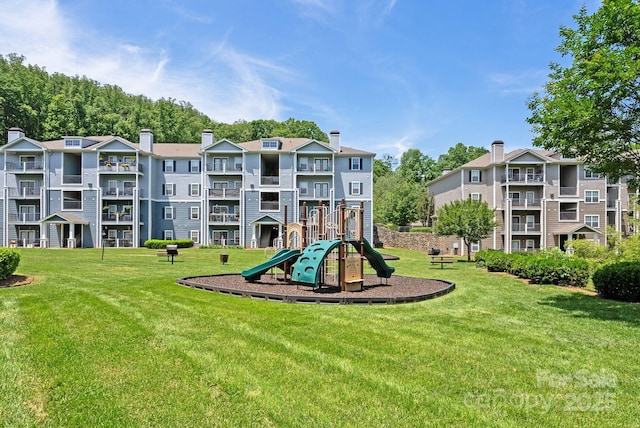 view of playground with a lawn
