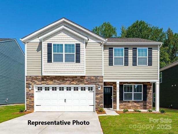 view of front facade with a garage and a front yard