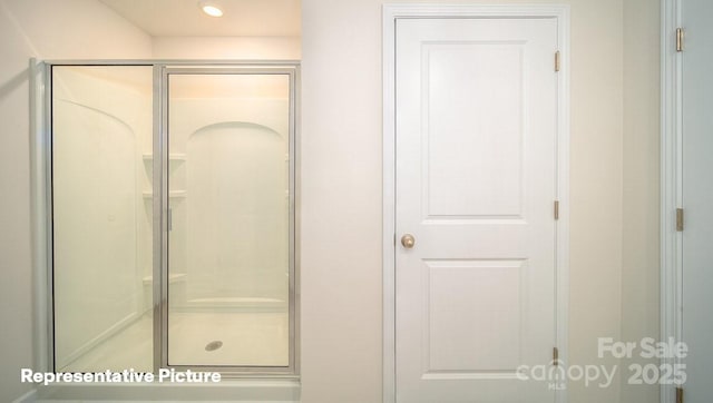 bathroom with a shower with door