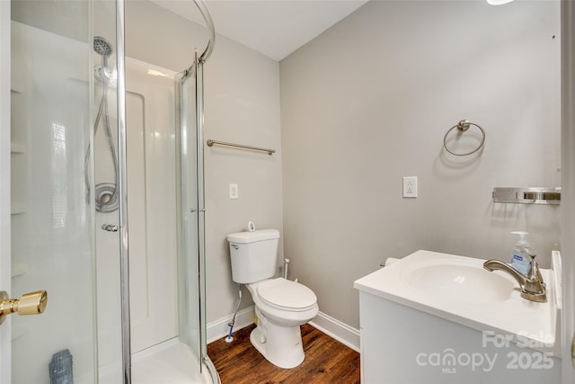 bathroom with vanity, an enclosed shower, hardwood / wood-style floors, and toilet