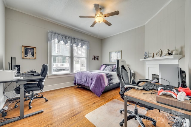 bedroom featuring crown molding, hardwood / wood-style floors, and ceiling fan