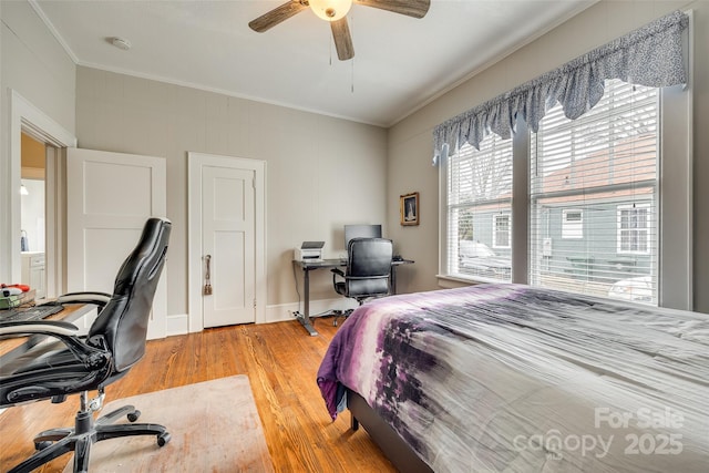 bedroom with crown molding, ceiling fan, and light hardwood / wood-style flooring