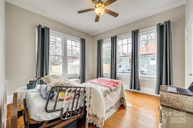 bedroom with ceiling fan and light hardwood / wood-style floors