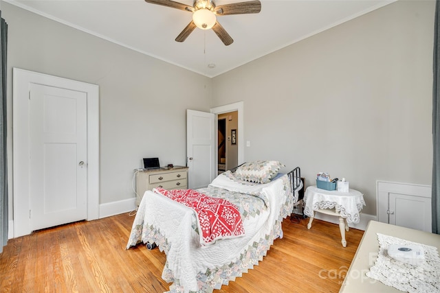 bedroom featuring hardwood / wood-style flooring, crown molding, and ceiling fan