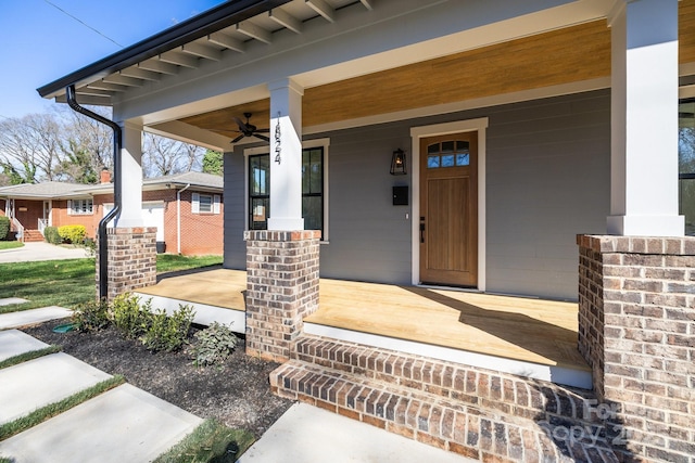 doorway to property with covered porch and ceiling fan