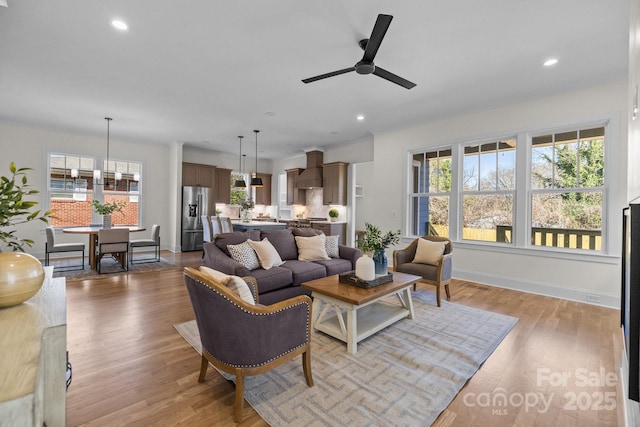 living room featuring recessed lighting, baseboards, and wood finished floors