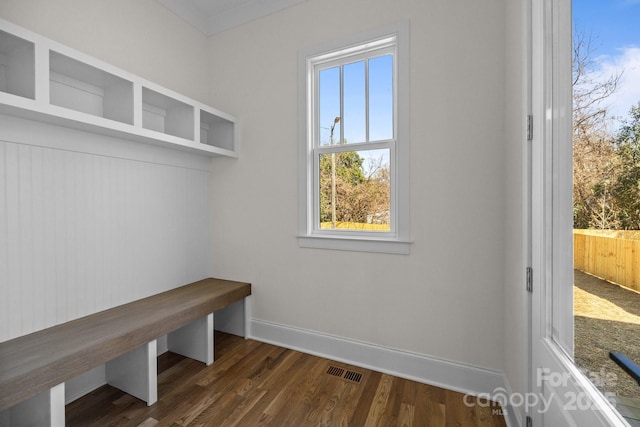 mudroom with dark wood-style floors, visible vents, and baseboards