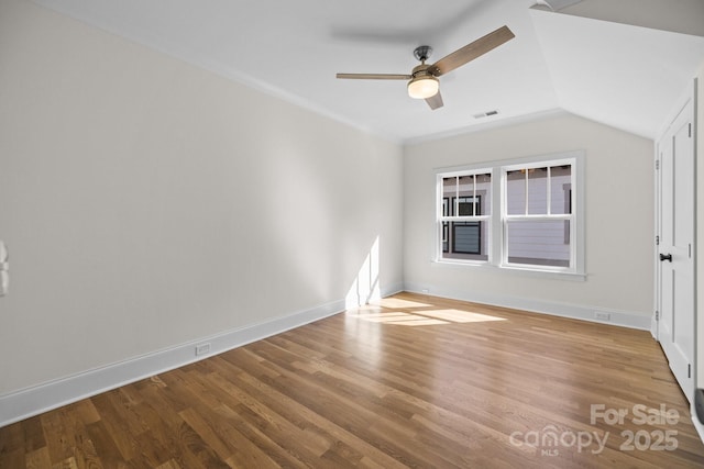 unfurnished room with visible vents, a ceiling fan, baseboards, and wood finished floors