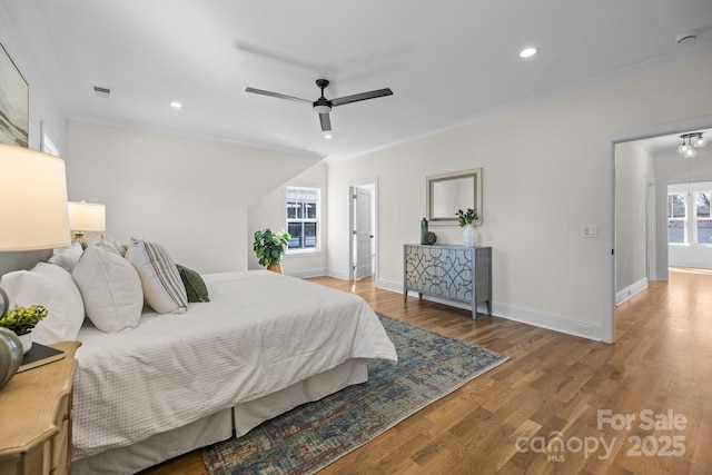 bedroom featuring recessed lighting, visible vents, baseboards, and wood finished floors