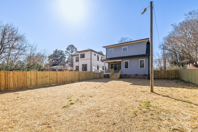 back of house featuring crawl space, covered porch, and a fenced backyard