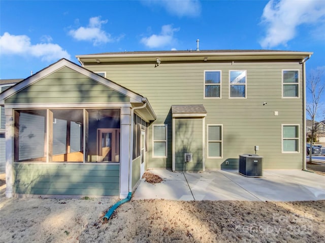 back of property with cooling unit, a patio area, and a sunroom