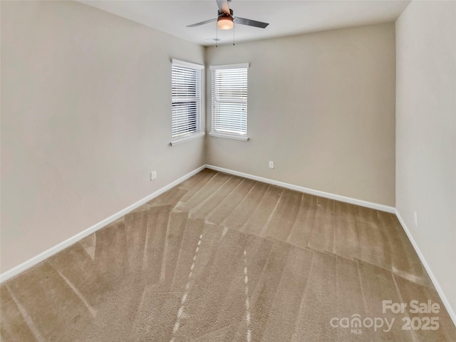 spare room with carpet floors and ceiling fan