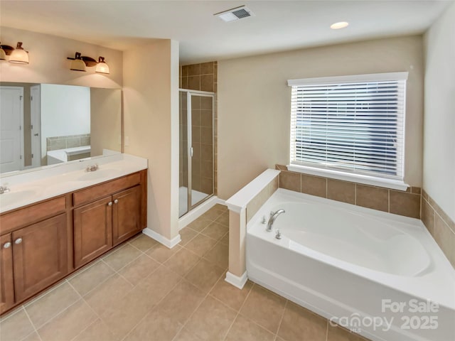 bathroom with tile patterned floors, vanity, and separate shower and tub