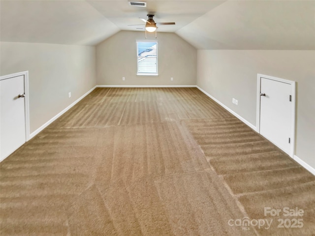 additional living space with vaulted ceiling, ceiling fan, and carpet