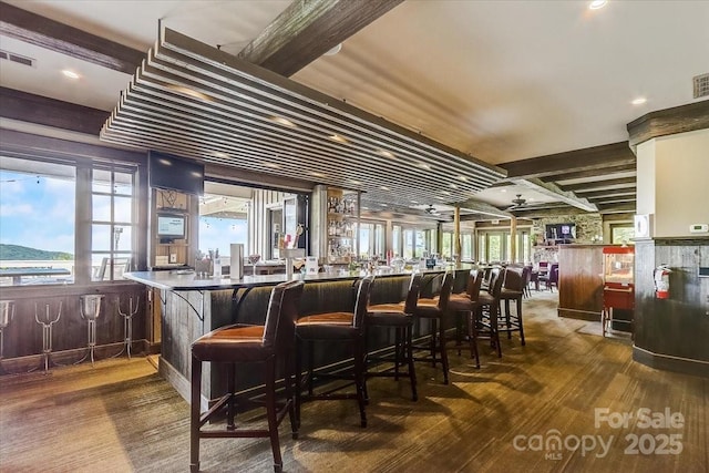 bar with beamed ceiling and hardwood / wood-style floors