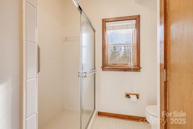 bathroom featuring walk in shower and toilet