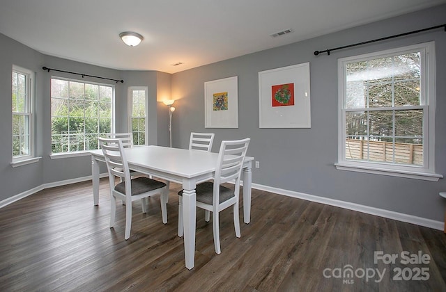 dining space with dark hardwood / wood-style floors