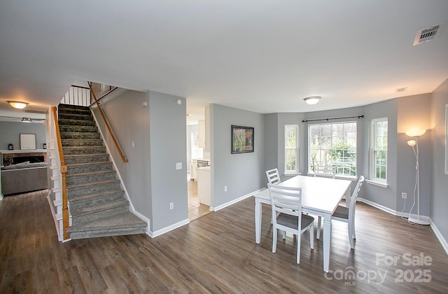 dining room with dark hardwood / wood-style flooring