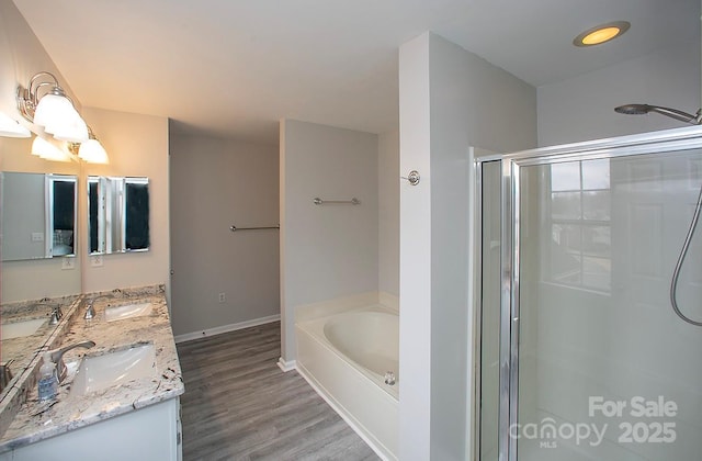 bathroom with vanity, independent shower and bath, and hardwood / wood-style floors