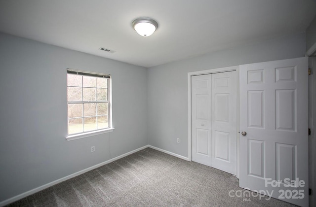 unfurnished bedroom featuring a closet and carpet flooring