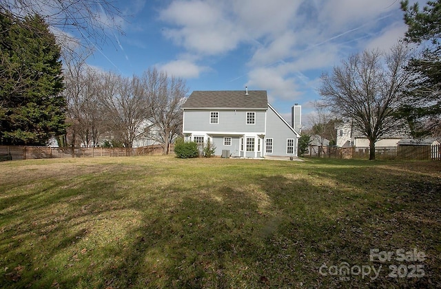 rear view of property with a yard