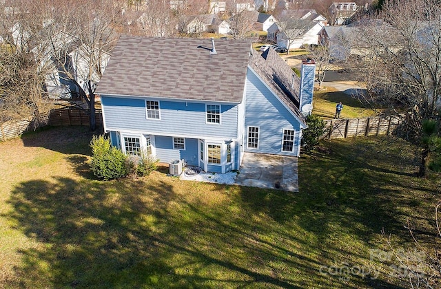 back of property featuring cooling unit, a patio area, and a lawn