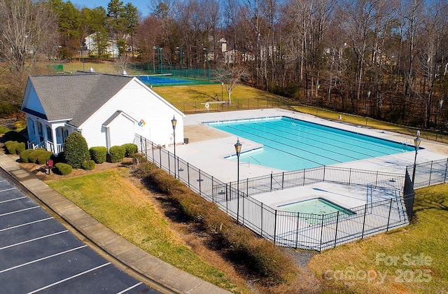 view of swimming pool featuring a yard and a patio area