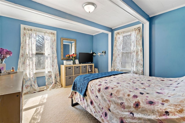 carpeted bedroom featuring ornamental molding and beamed ceiling