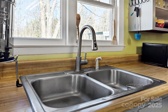 interior details with a hot tub and a sink