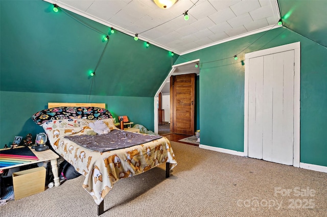 bedroom featuring lofted ceiling, ornamental molding, carpet, and baseboards