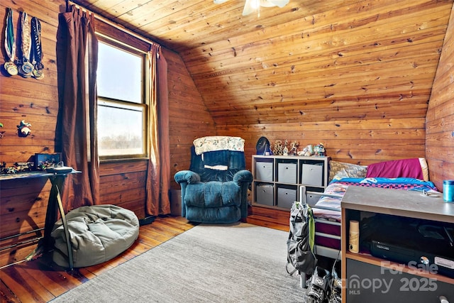 bedroom featuring vaulted ceiling, wood walls, and wood ceiling