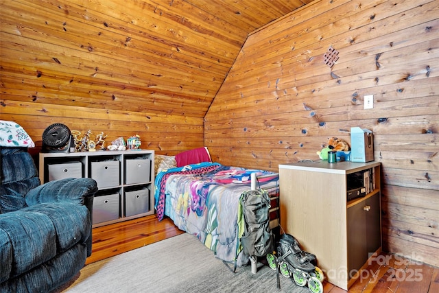 bedroom with lofted ceiling, light wood-style floors, wood ceiling, and wood walls