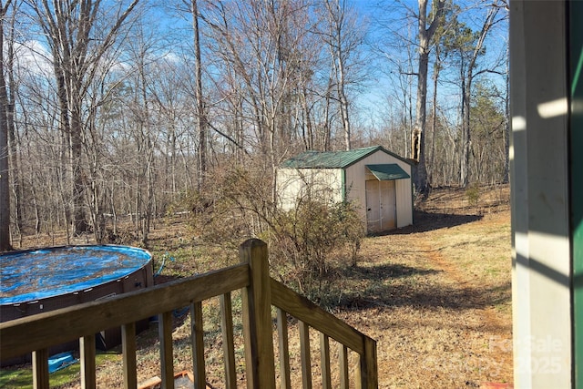 view of yard featuring a storage shed and an outbuilding