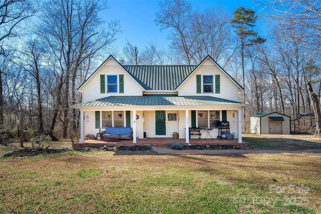 view of front of property with a front lawn, covered porch, an outdoor structure, and a storage shed