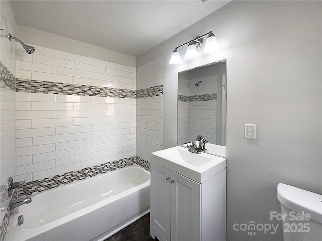 full bathroom with tiled shower / bath combo, vanity, and toilet