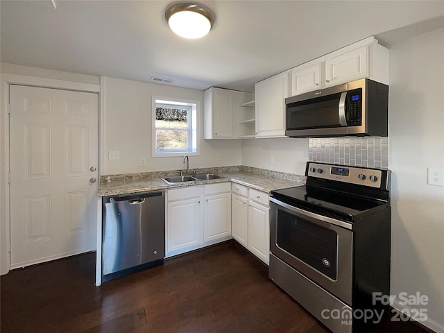 kitchen with sink, backsplash, stainless steel appliances, dark hardwood / wood-style floors, and white cabinets