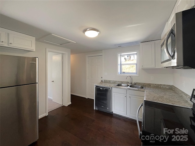 kitchen featuring stainless steel appliances, white cabinetry, sink, and dark hardwood / wood-style flooring