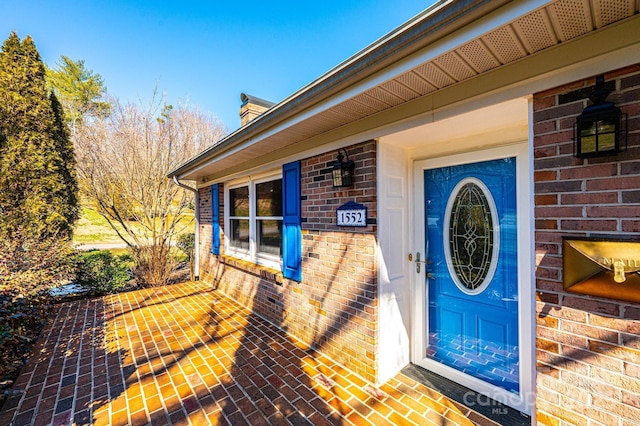 property entrance with brick siding