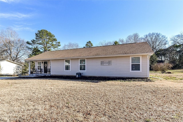 back of property featuring a yard