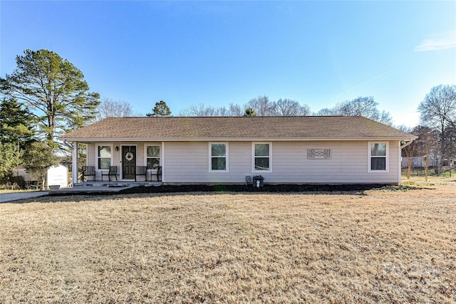 view of front of home with a porch and a front yard