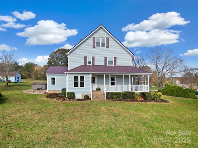 rear view of house featuring cooling unit, a yard, a hot tub, and covered porch