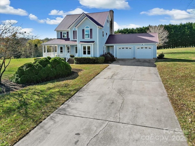 view of front of home with a garage, a front lawn, and a porch