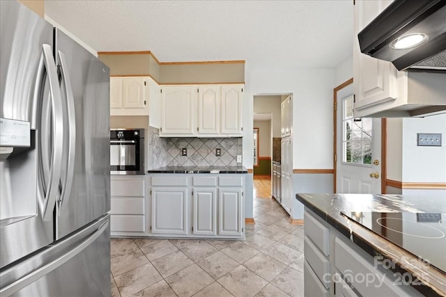 kitchen with white cabinetry, extractor fan, a textured ceiling, and appliances with stainless steel finishes