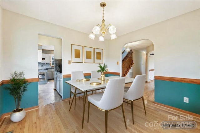 dining room with a chandelier and light hardwood / wood-style flooring