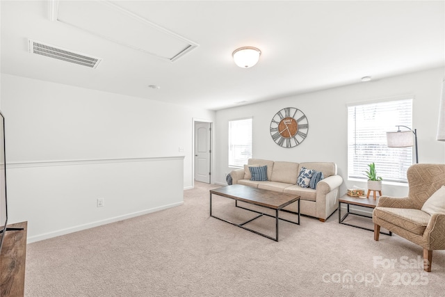 living area with carpet floors, visible vents, and baseboards