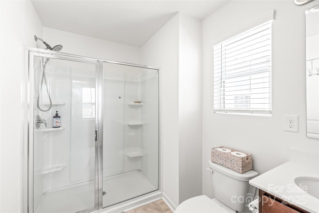 full bathroom with toilet, a stall shower, and vanity