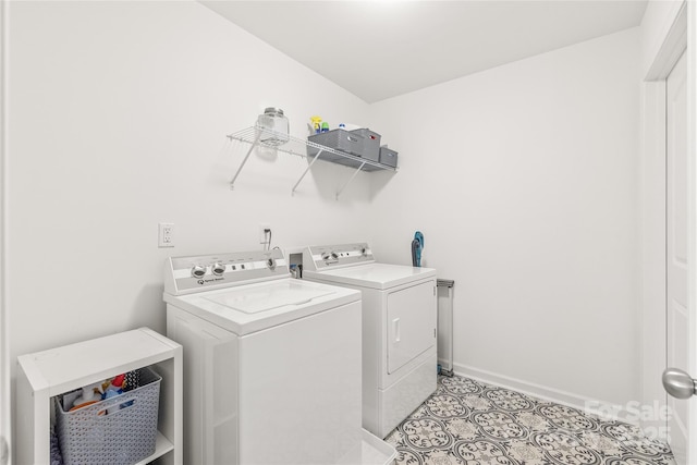 laundry room featuring baseboards, laundry area, light tile patterned flooring, and washer and dryer